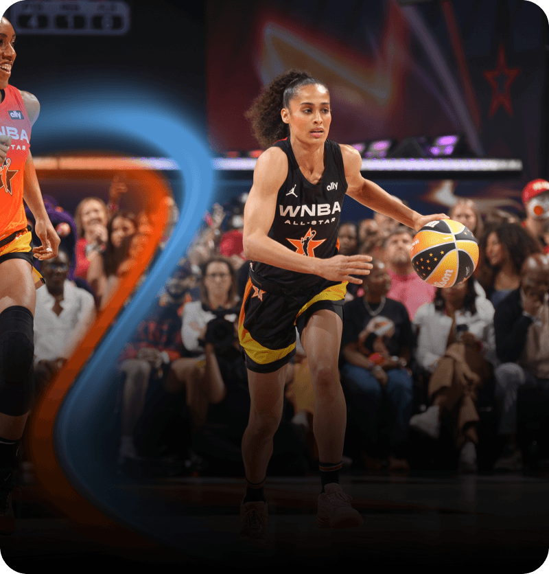 WNBA All-Star player dibbles the basketball during All-Star Game with fans in the background
